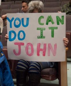 Laurie Curl holds a sign encouraging Supervisor John Gillespie to vote against the Vineyard Commons play. Gillespie voted to approve.