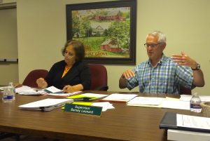 Pocopson Township Supervisor Ricki Stumpo (left) listens as Supervisors' Chairman Barney Leonard discusses the Barnard House project. 