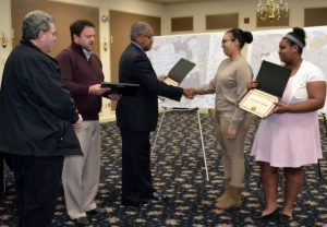 Kennett Square Mayor Matt Fetick (from left) and Borough Council President Leon R. Spencer Jr. present plaques to 
