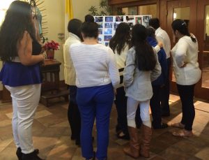 Mourners gather around one of the photo collages at the viewing for Brian R. Ayllon, 16, of Kennett Township.