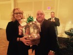 Lisa Vonderstruk, Brandywine View Antiques, is presented a gift basket by Larry Ferriola of Concord Autobody