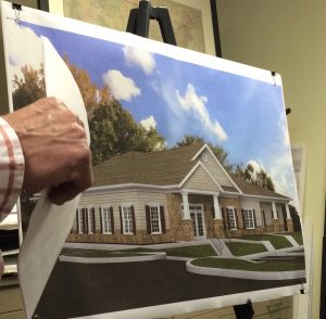 Victor Kelly, an engineer, display a rendering of the proposed daycare facility at the Riverside at Chadds Ford community.