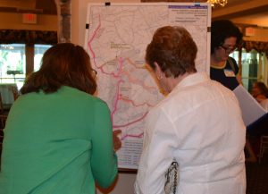 Attendees at the Brandwyine Battlefield Task Force Celebratory Event inspect some of the maps prepared during the Brandywine Battlefield research.