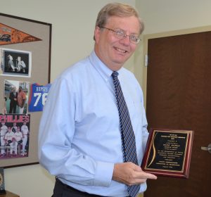 Displaying his Outstanding Chief Clerk Award, Mark Rupsis credits the people around him for any success he's had.