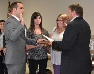 Kevin Thompson (left) is sworn in as a part-time police officer by Kennett Square Mayor Matt Fetick (right).