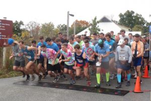 Oblivious to the wind and rain, racers take off with a burst of energy and enthusiasm.