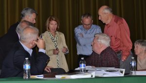Kristen Camp (center), the solicitor for the Westtown Township Planning Commission, confers with members after the meeting.